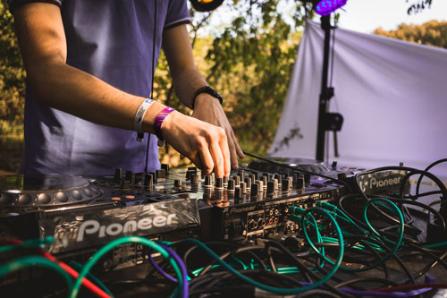 young man at DJ table on stage